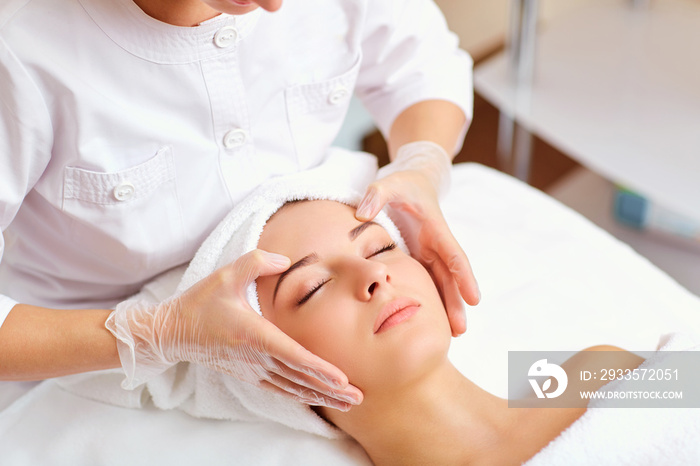 Beautiful woman at a facial massage at a spa salon.