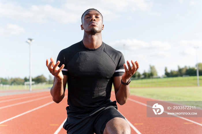 Athlete preparing to sprint at running track