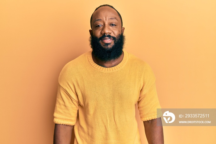 Young african american man wearing casual clothes relaxed with serious expression on face. simple and natural looking at the camera.