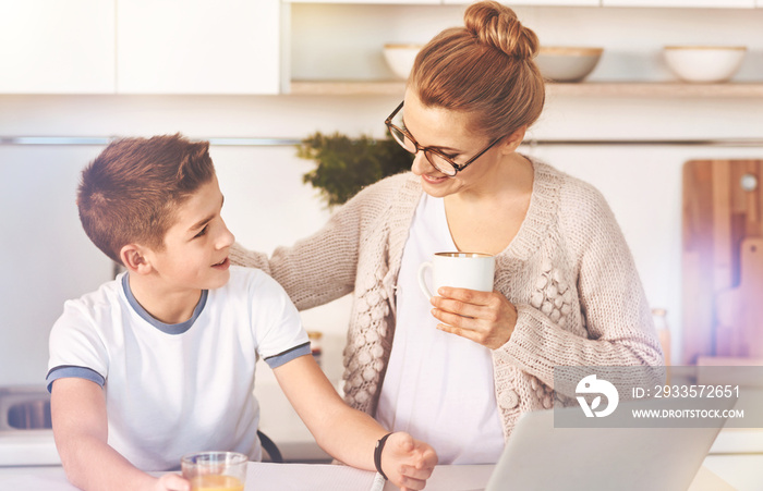 Take a break. Delighted boy turning his head to his mom and expressing positivity while looking aside