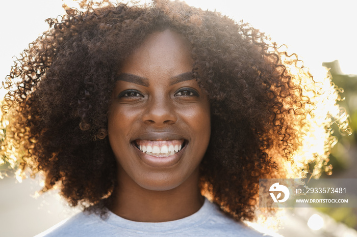 Young african american girl smiling on camera outdoor in the city - Focus on face