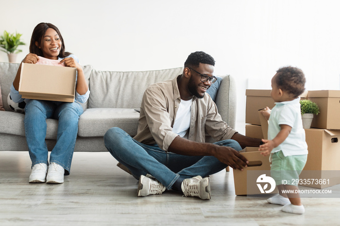 Happy African American family moving in new apartment