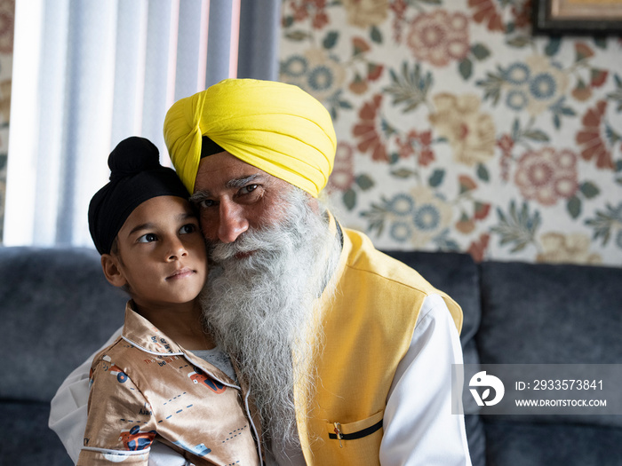 Portrait of grandfather and grandson (6-7) in traditional clothing