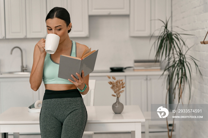 Female with coffee engaged in reading at home stock photo