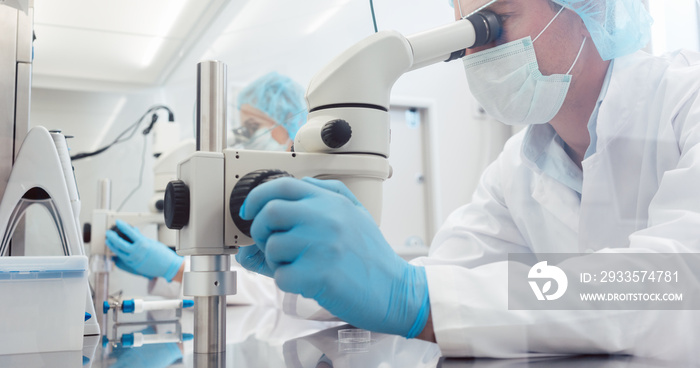 Lab technicians of scientists working on developing a vaccine