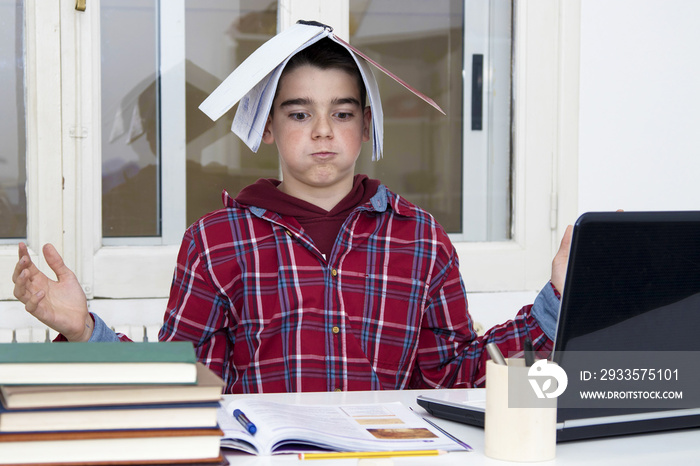 child tired and stressed at the school desk