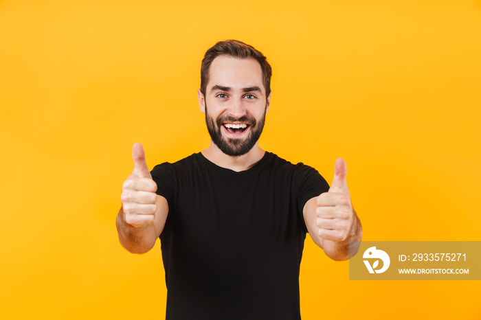 Image of pleased man wearing t-shirt smiling and gesturing thumbs up