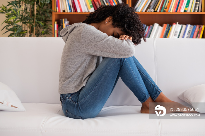 Black girl portrait feeling sad and lonely at home