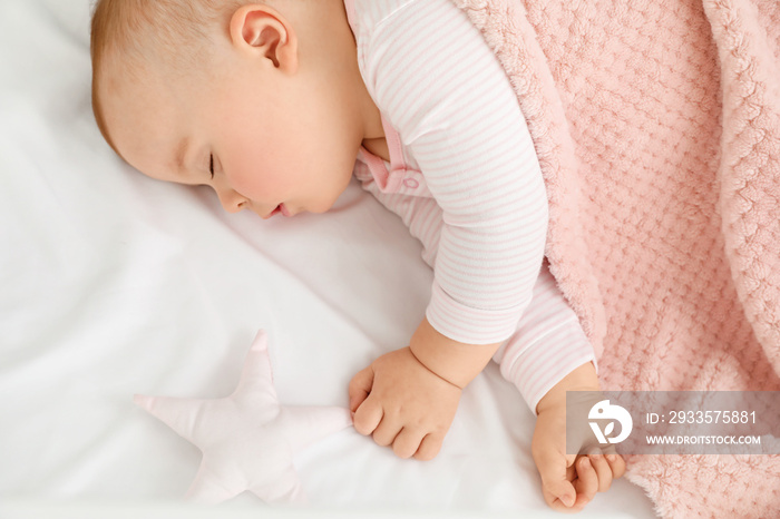 Cute sleeping little baby in bed