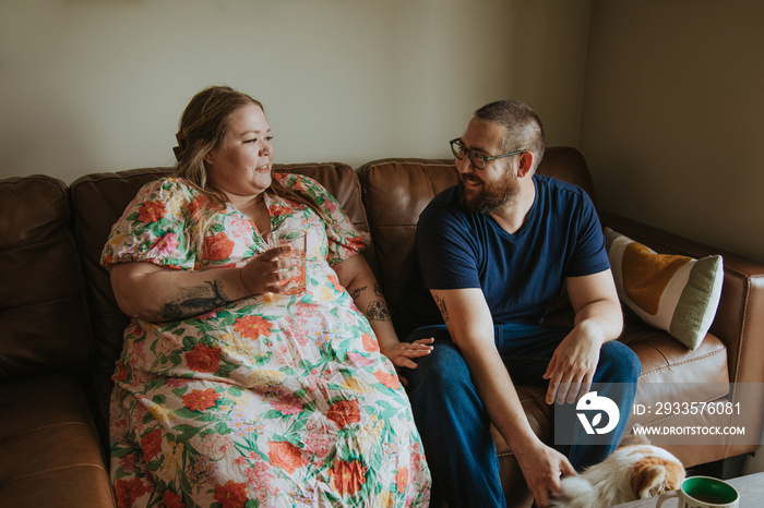 couple talking on sofa