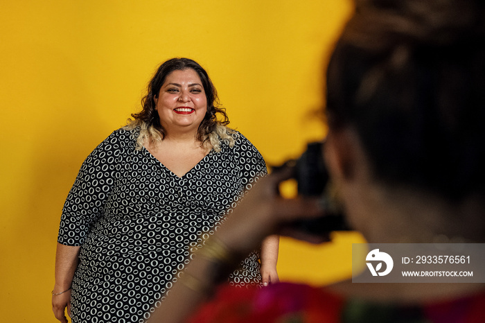 Plus sized female getting her headshots taken by a south asian female photographer