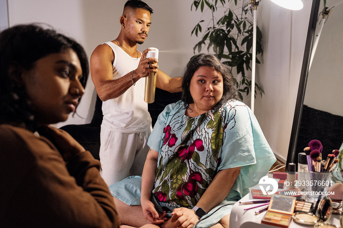 Group of friends doing each others make up at home during a sleepover