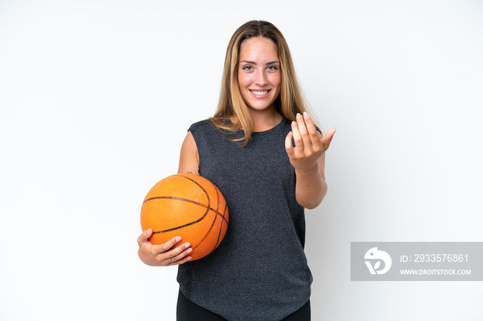 Young basketball caucasian player woman isolated on white background inviting to come with hand. Happy that you came