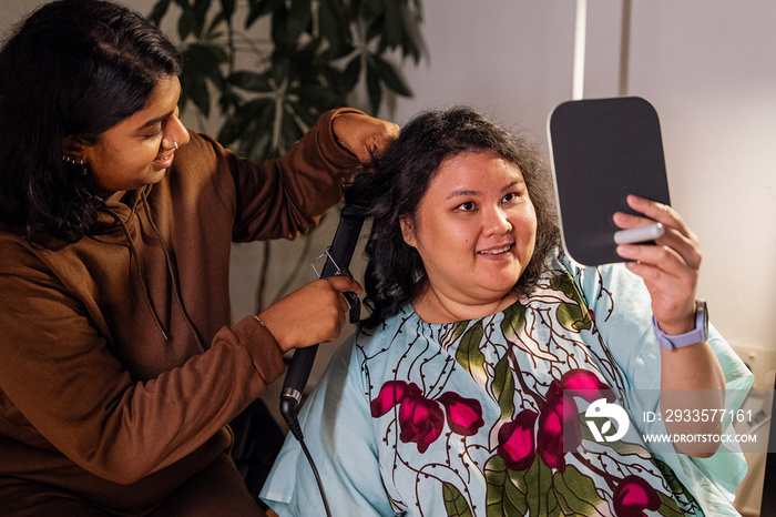 Group of friends doing each others make up at home during a sleepover