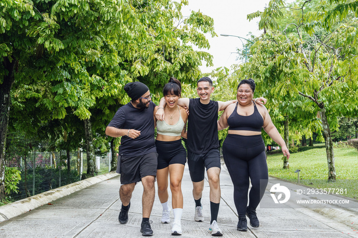 Group of friends walking together in the park, hugging