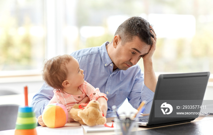remote job, multi-tasking and family concept - tired middle-aged father with baby working on laptop at home office