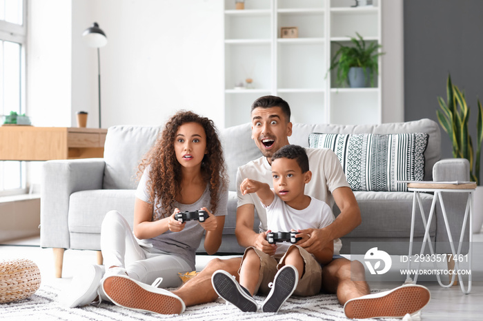 Happy interracial family playing video game at home