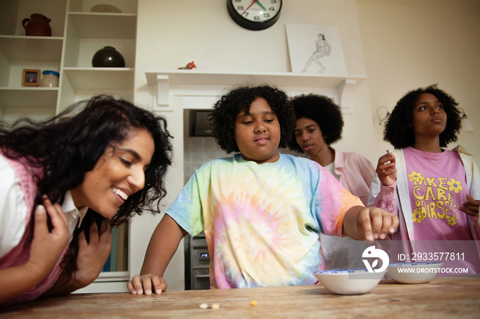 Curvy woman having fun in the kitchen with her three children