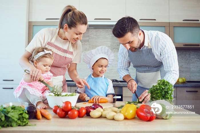 A happy family is preparing vegetables in the kitchen.