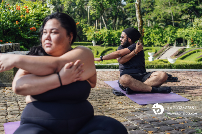 Group of friends doing yoga in the park together