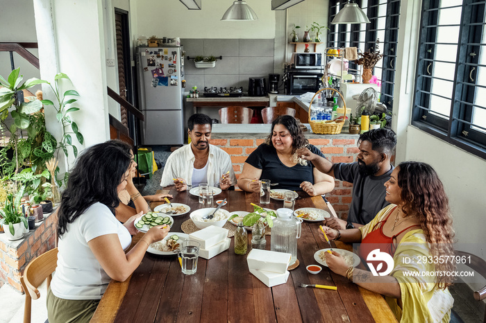 Group of friends sharing a meal together at home