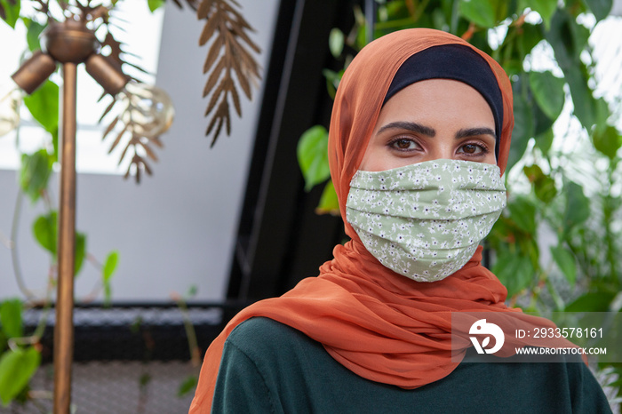 Portrait of woman wearing headscarf and face mask