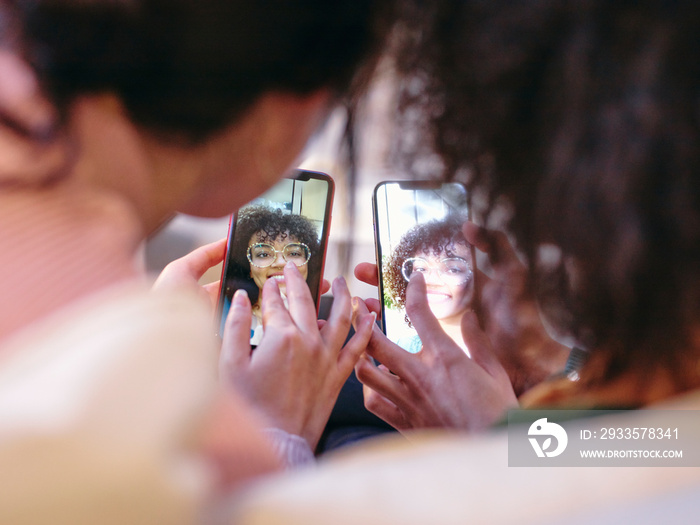 Close-up of two women looking at smart phones