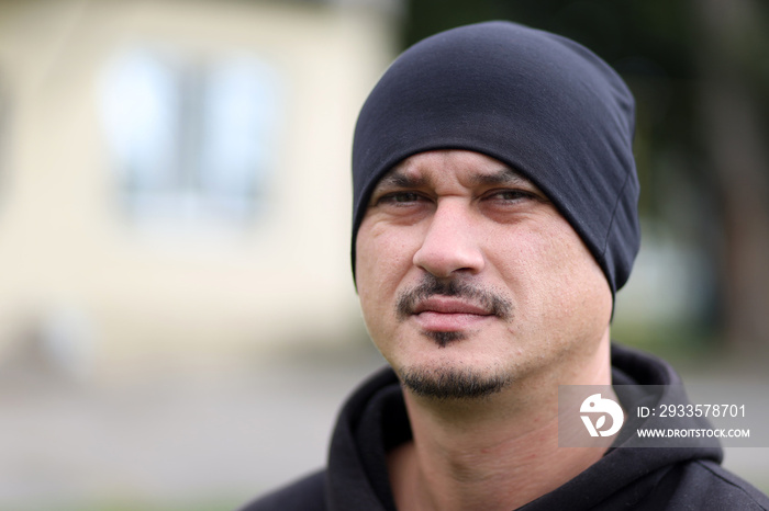 Close-up portrait of a serious man outdoors