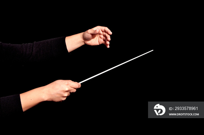 Orchestra woman conductor music conducting. Hands of conductor with baton on black background