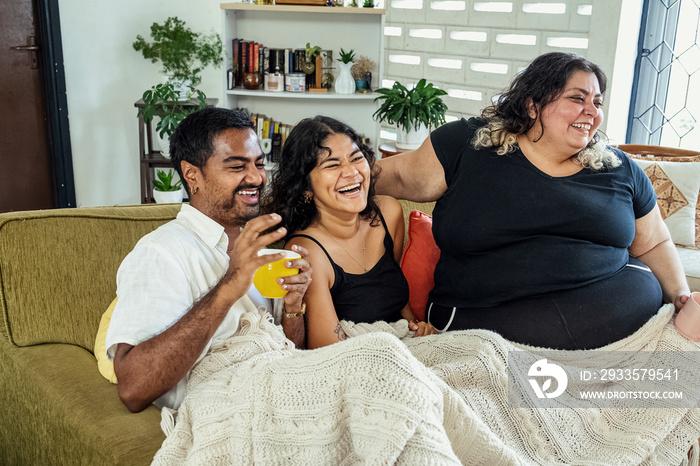 Friends watching tv together at home