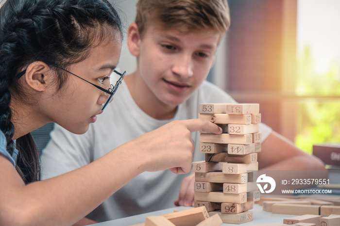 teenagers play Jenga game together