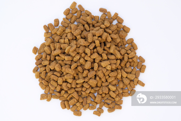 Dry cat food on a white background. Brown granules of dry food for adult sterilized cats. Small granules with turkey flavor food for domestic cats.