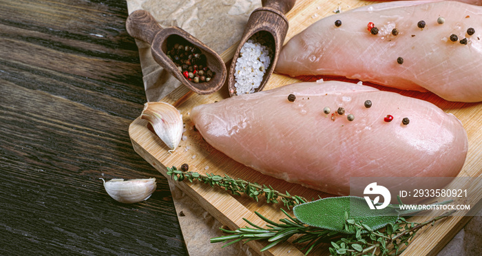 fresh raw farm chicken fillet on a cutting board.