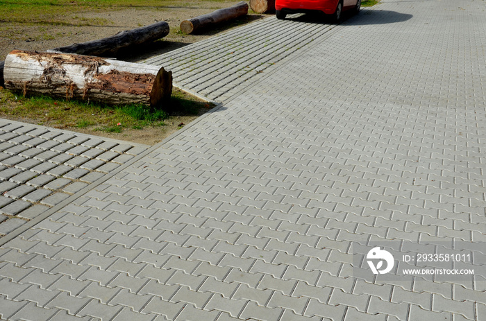 absorbent porous paving absorbs a lot of rainwater in a city parking lot. border against vehicles on the shoulder at the entrance to the lawn. infiltration gaps with gravel.