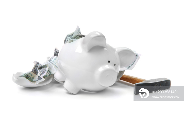 Broken piggy bank with money and hammer on white background