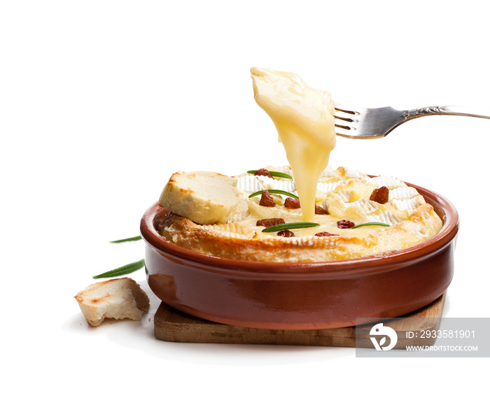 Delicious  hot baked camembert with sultanas isolated on white