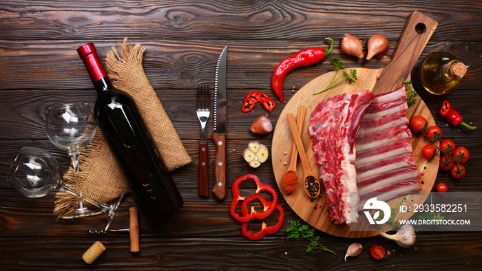 Lamb ribs with spices and vegetables and a bottle of red wine