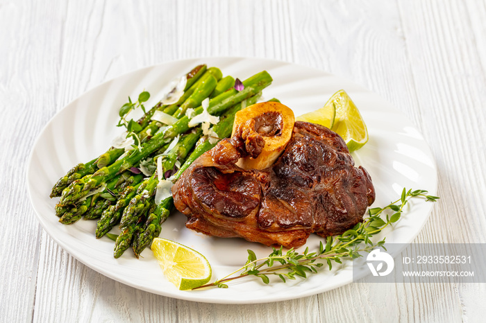 braised osso buco with grilled asparagus, top view