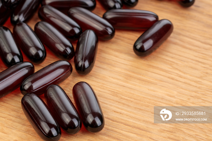 Close up of Omega 3 capsules on wooden background. Copy text space. High resolution of the product. Health care concept.