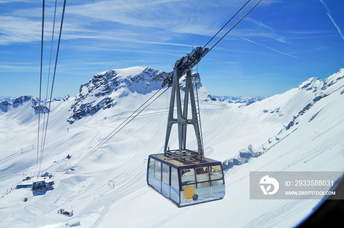 Breathtaking scenic landscape Alpine mountain range view with cable car on top of Zugspitze summit in Bavarian Alps with glaciers, ski slopes or runs and blue sky
