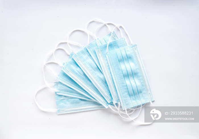 A pile of disposable medical masks to protect the mouth and nose. Coronavirus concept and prevention