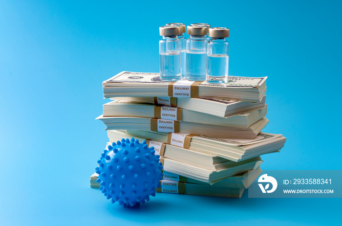 Big pharma profiteering, healthcare corruption and pharmaceutical industry greed concept with vaccine vials on top of huge pile of money and coronavirus model isolated on blue background