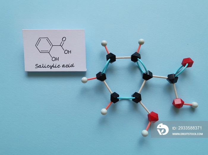 Molecular structure model and structural chemical formula of salicylic acid molecule. Salicylic acid is a type of phenolic acid, it is used as a key ingredient in topical anti-acne products.