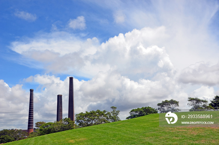 Dramatic blue cloud filled sky over the historic abandoned Bedford brick works chimneys in Sydney Park, St Peters, NSW, Australia