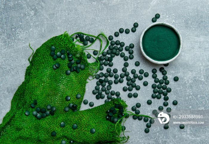 Chlorella or spirulina tablets close up. Nutrition and dietary dupplements. Vegan Protein.