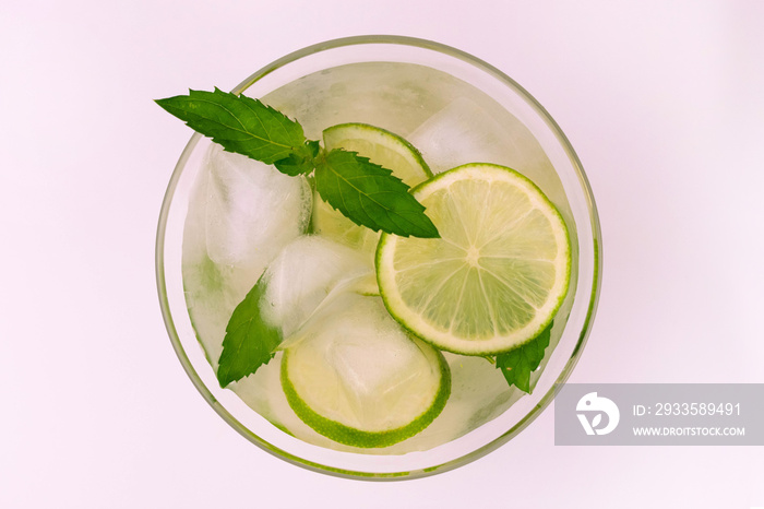 Green ice tea with lime and mint on a white background. View from above.