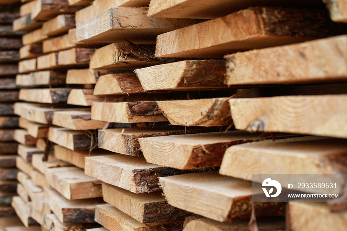 Close up of unedged board of soft wood stacked for drying. Selective focus.