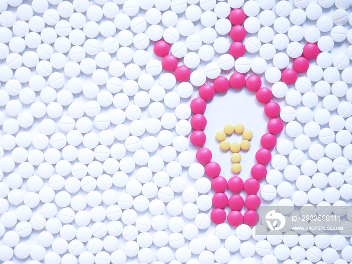 Light bulb with sparkle made by unique pink medicine pills among white ones background. Research and development in the pharmaceutical industry concept. Creative medicine idea. Copy space.