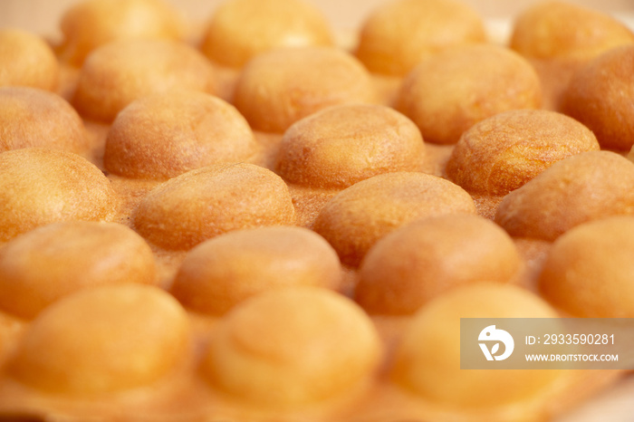 Close-up dessert Waffle Hong Kong or bubble waffle on wood background.