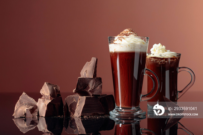 Hot chocolate with whipped cream and pieces of dark chocolate.